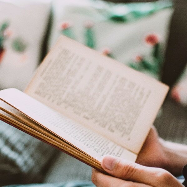 close-up-photo-of-person-holding-book-1485114
